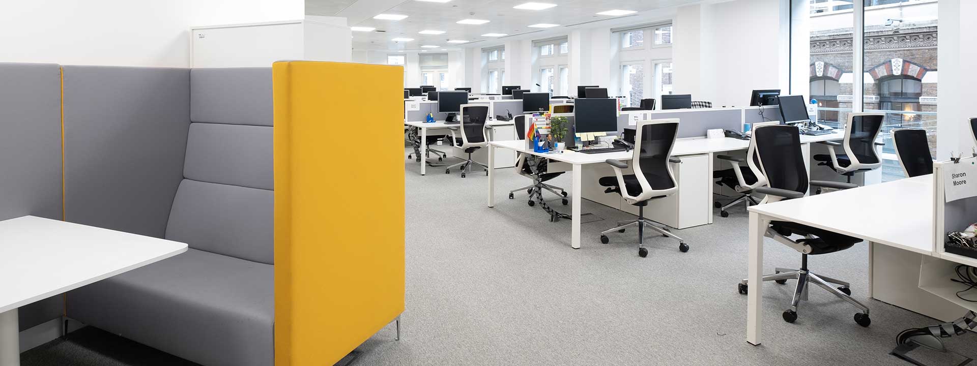 Open plan office with yellow sofa