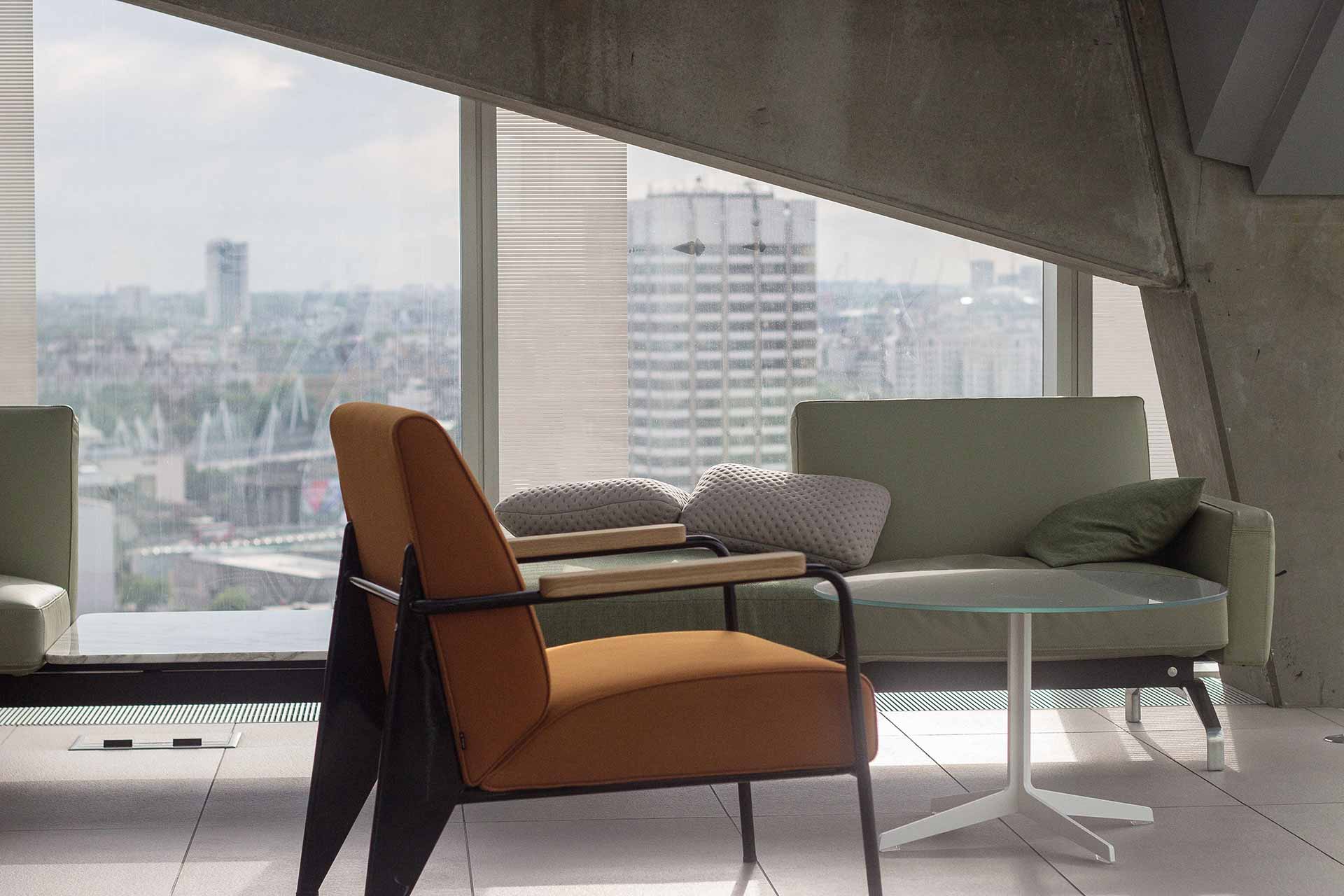 Brown sofa chair and cream sofa chair on high office floor