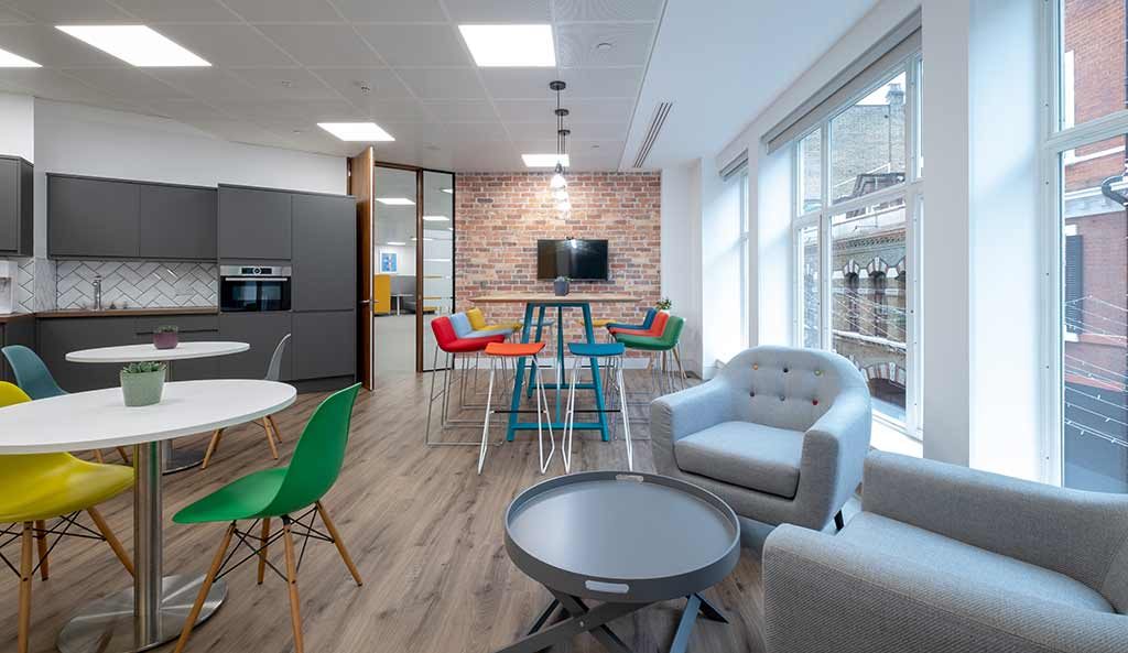 Open plan office space with brightly coloured chairs