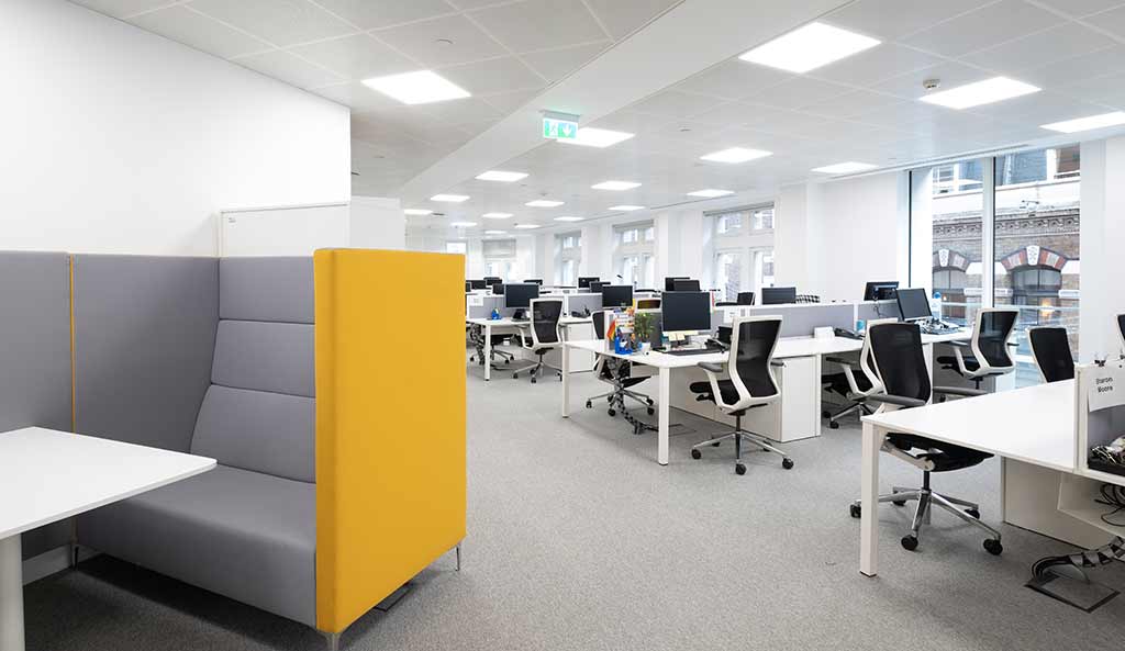Open plan office with yellow sofa