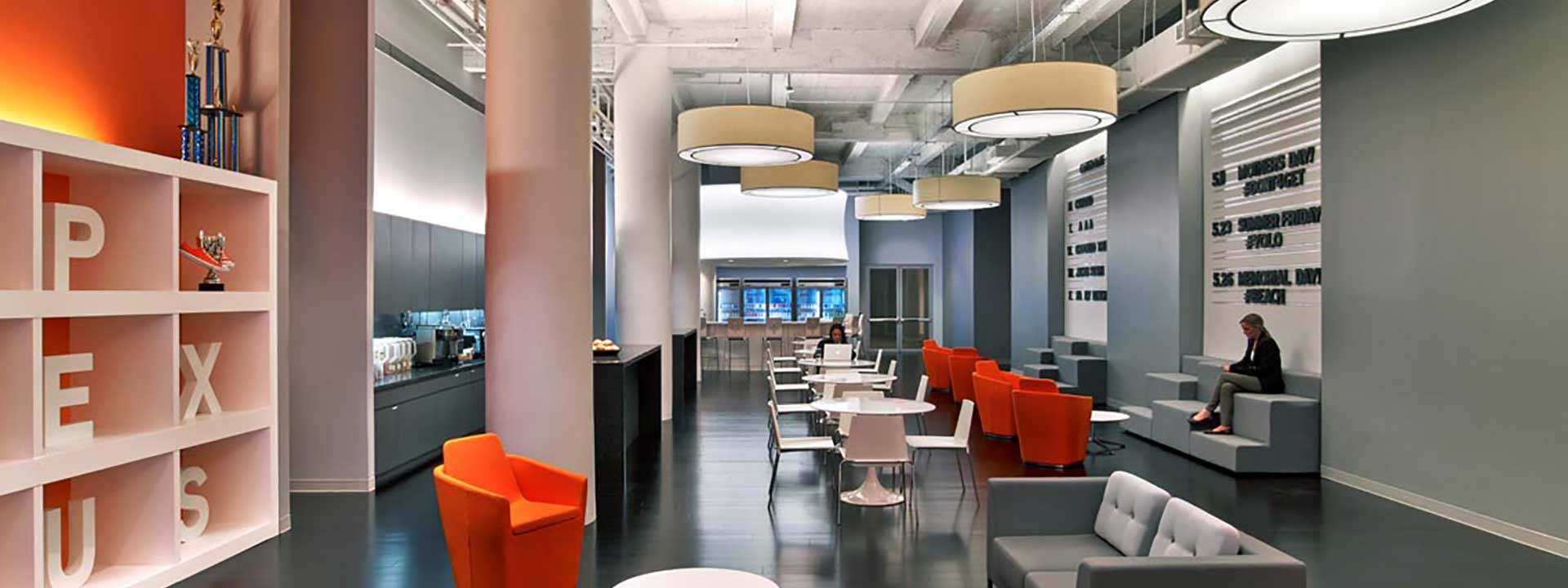 Modern office design with tables, chairs, sofas, a coffee machine section and a bar