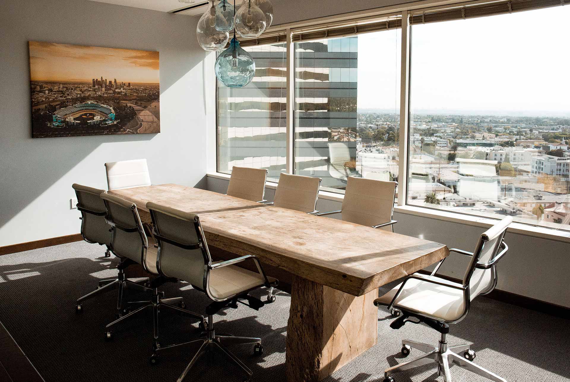tailored office with oak table, modern chairs and a view to the city