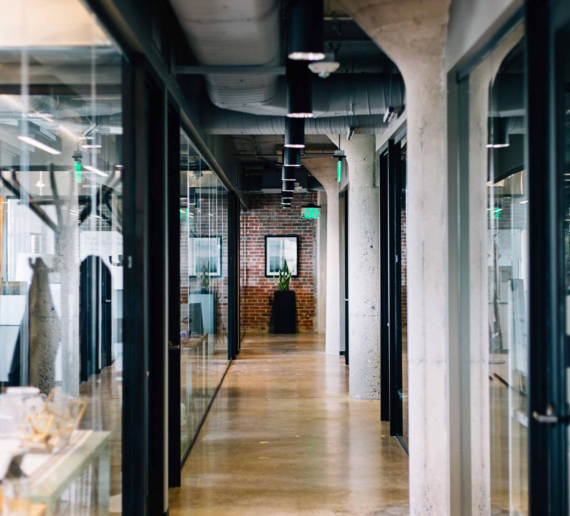 Modern office hallway with glass walls at each side