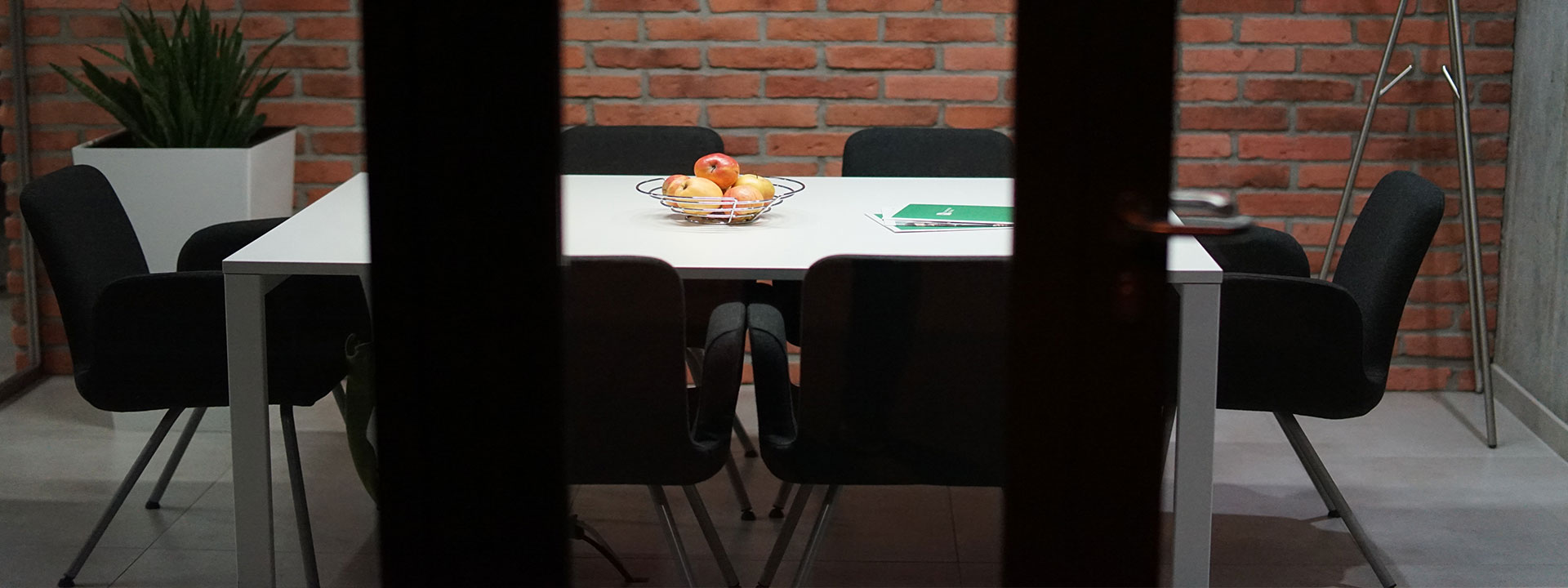 looking into a meeting room with table and chairs