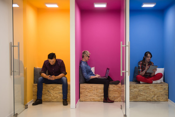 Yellow, pink and blue leisure spaces with employees working comfortably