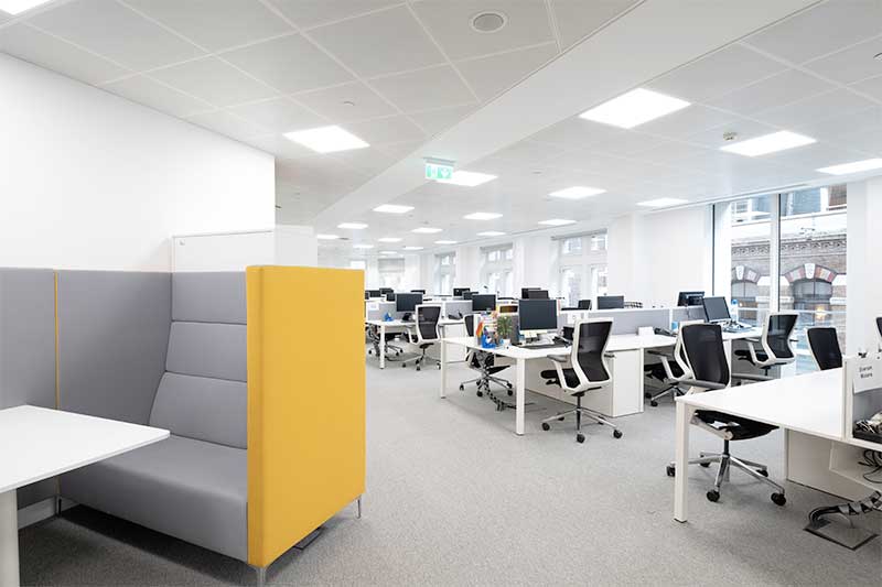 Open plan office with yellow sofa